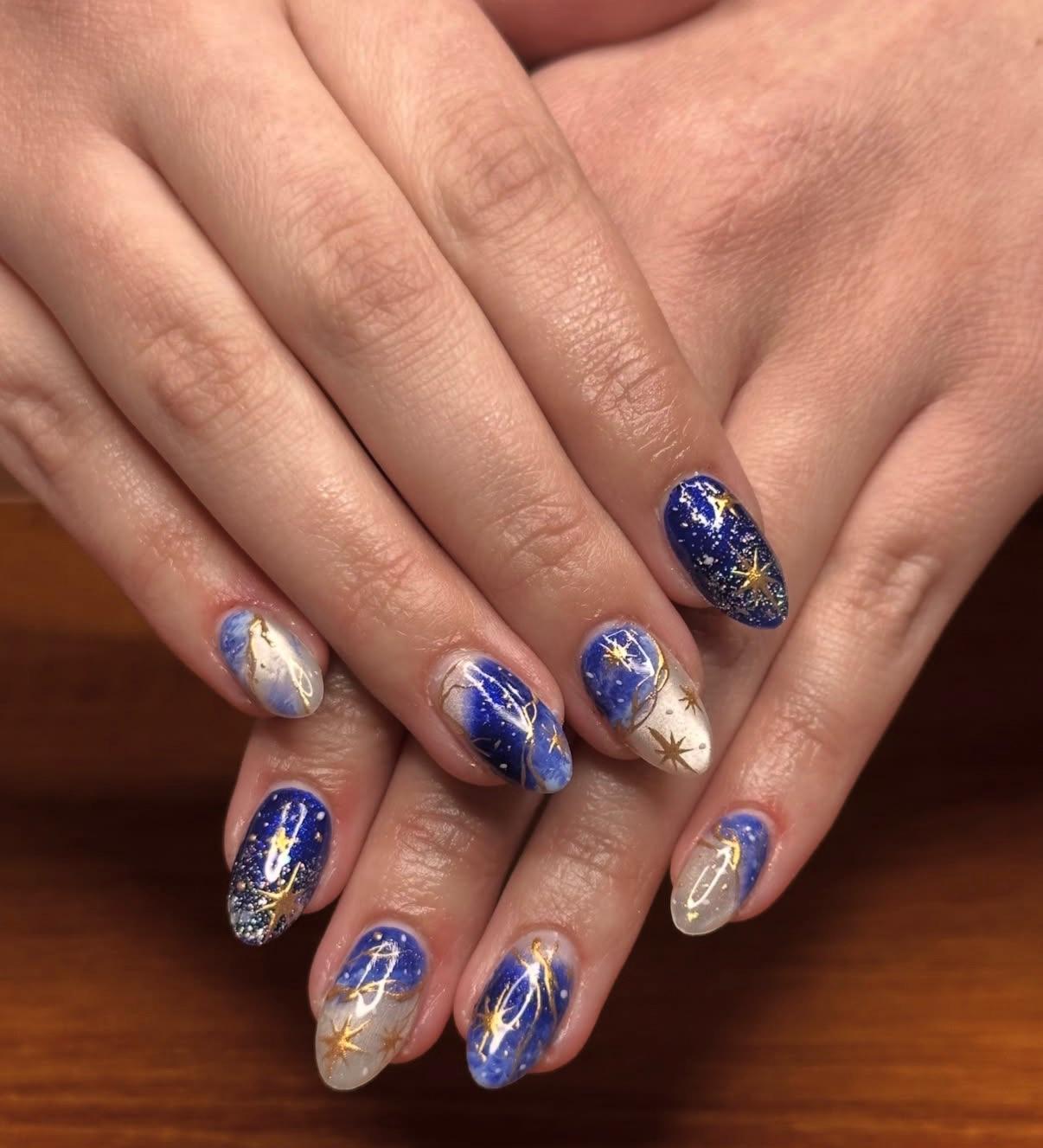 Blue celestial nail art with star details